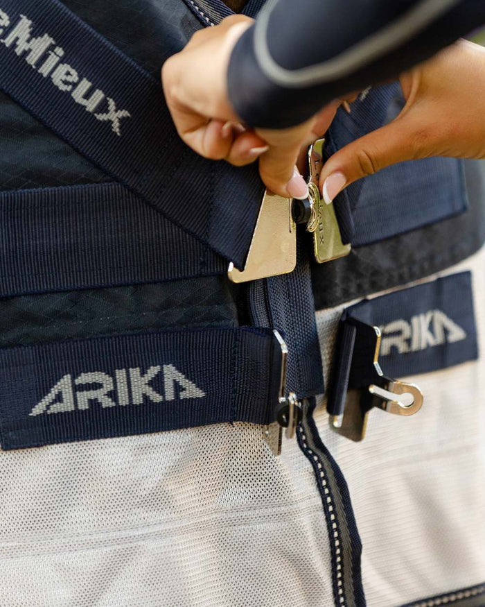 Navy coloured LeMieux Arika Shower Tek Fly Rug on blurry background #colour_navy