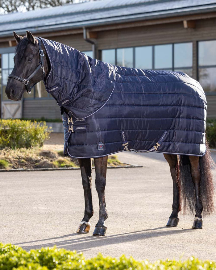 Navy coloured LeMieux Arika Stable-Tek 100g on outdoor background #colour_navy