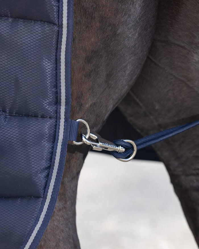 Navy coloured LeMieux Arika Stable-Tek 100g on outdoor background #colour_navy
