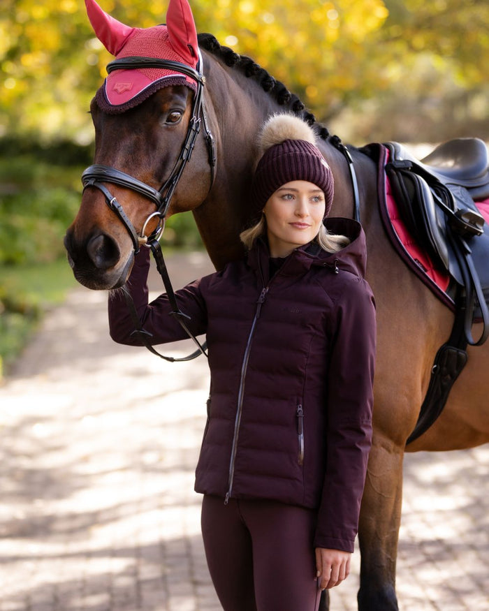 Damson coloured LeMieux Brooke Waterproof Hybrid Jacket on park background #colour_damson