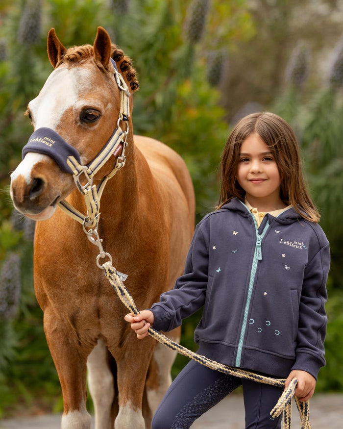 Dusk Blue coloured LeMieux Childrens Mini Charlie Zip Through Hoodie on backyard background #colour_dusk-blue