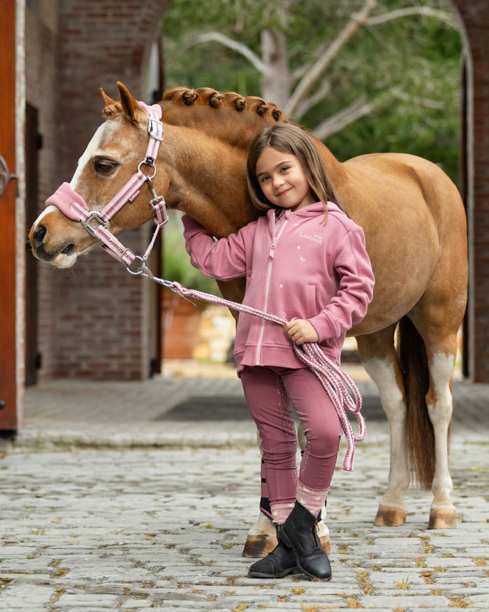 Peony coloured LeMieux Childrens Mini Charlie Zip Through Hoodie on backyard background #colour_peony