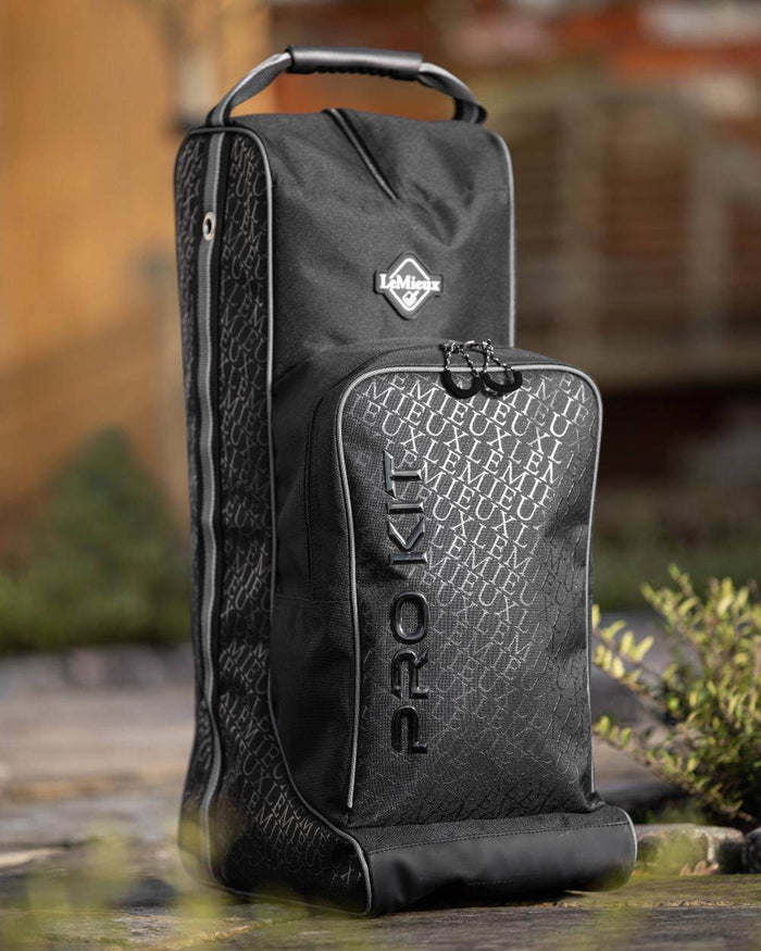 Black coloured LeMieux Elite Pro Boot & Hat Bag on blurry background #colour_black
