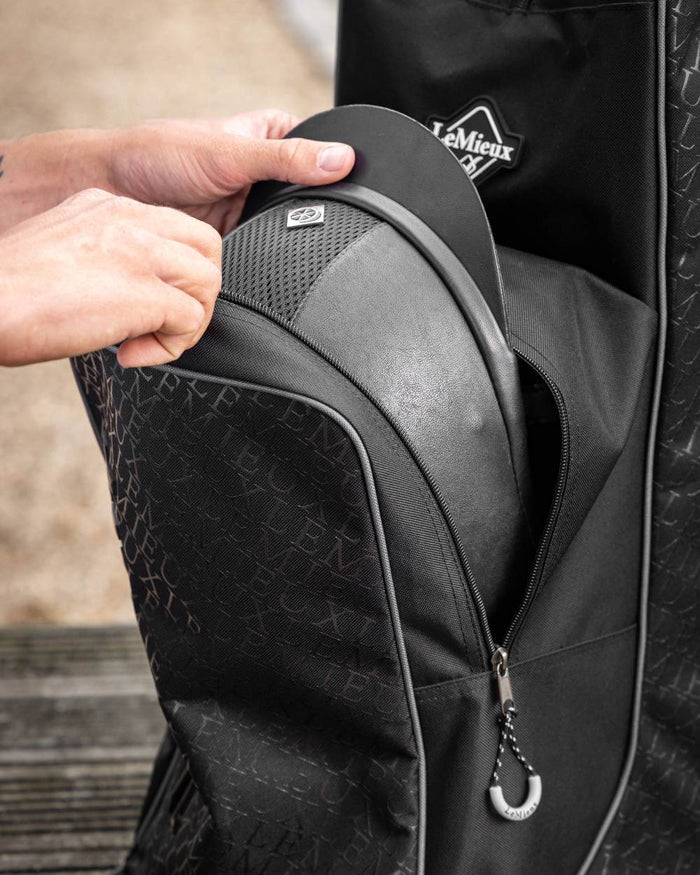 Black coloured LeMieux Elite Pro Boot & Hat Bag on blurry background #colour_black