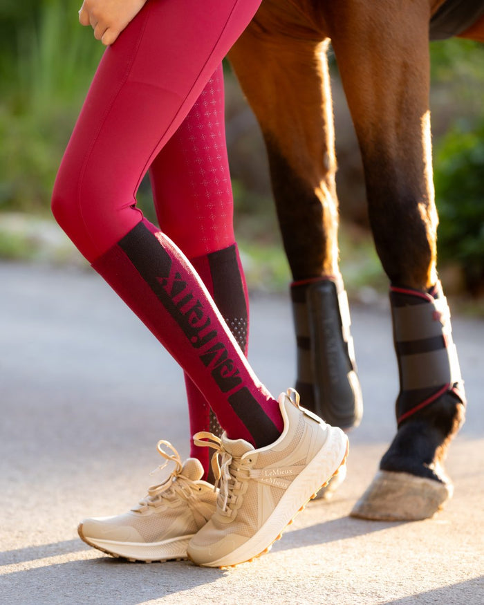 Ember Coloured LeMieux Silicone Socks On A Street Background #colour_ember