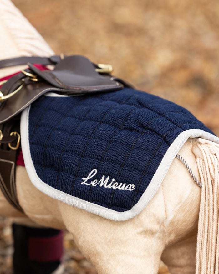 Navy coloured LeMieux Toy Pony Quarter Sheet on blurry background #colour_navy