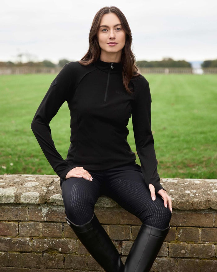 Black coloured LeMieux Frances Quarter Zip Fleece on grassy background #colour_black