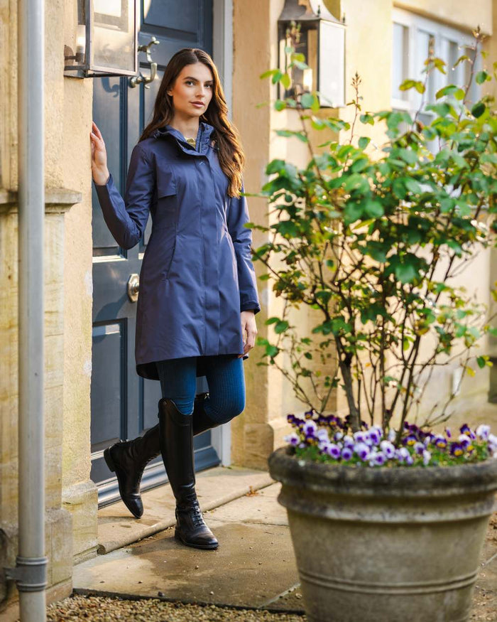 Dusk Blue coloured LeMieux Womens Grace Long Rain Jacket on street background #colour_dusk-blue