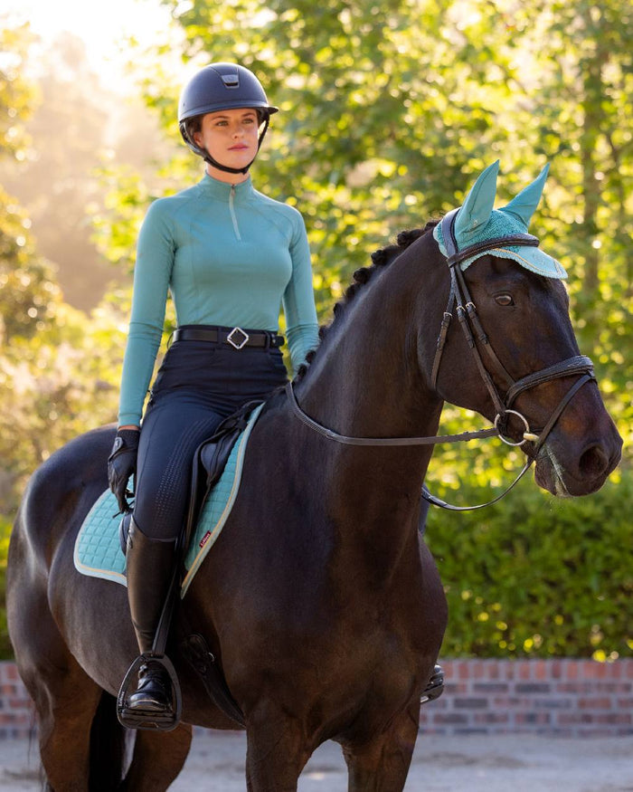 Lagoon coloured LeMieux Womens Halle Lightweight Base Layer on street background #colour_lagoon