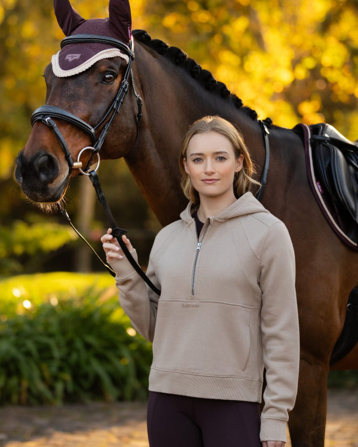 Almond coloured LeMieux Womens Henrietta Half Zip Hoodie on tree background #colour_almond