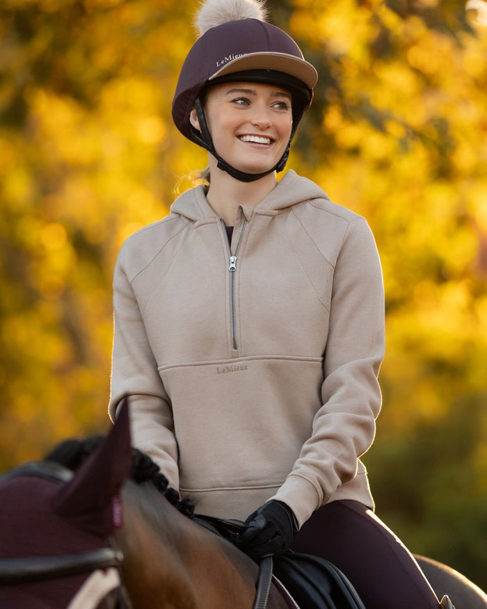 Almond coloured LeMieux Womens Henrietta Half Zip Hoodie on tree background #colour_almond