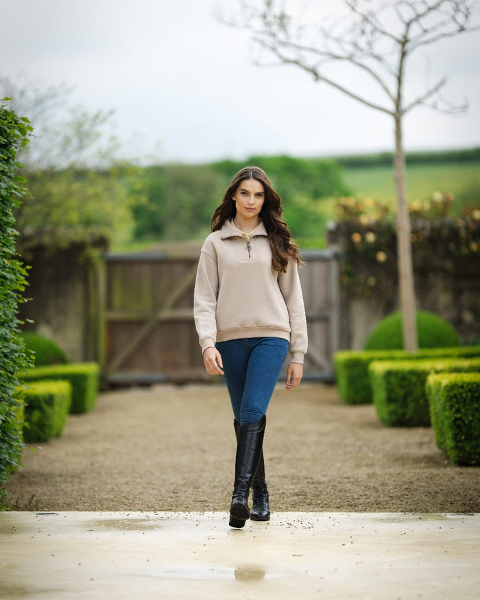 Almond coloured LeMieux Womens Keira Quarter Neck Sweatshirt on backyard background #colour_almond