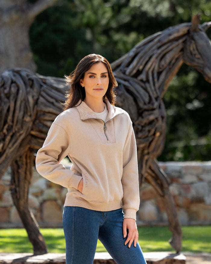 Almond coloured LeMieux Womens Keira Quarter Neck Sweatshirt on backyard background #colour_almond