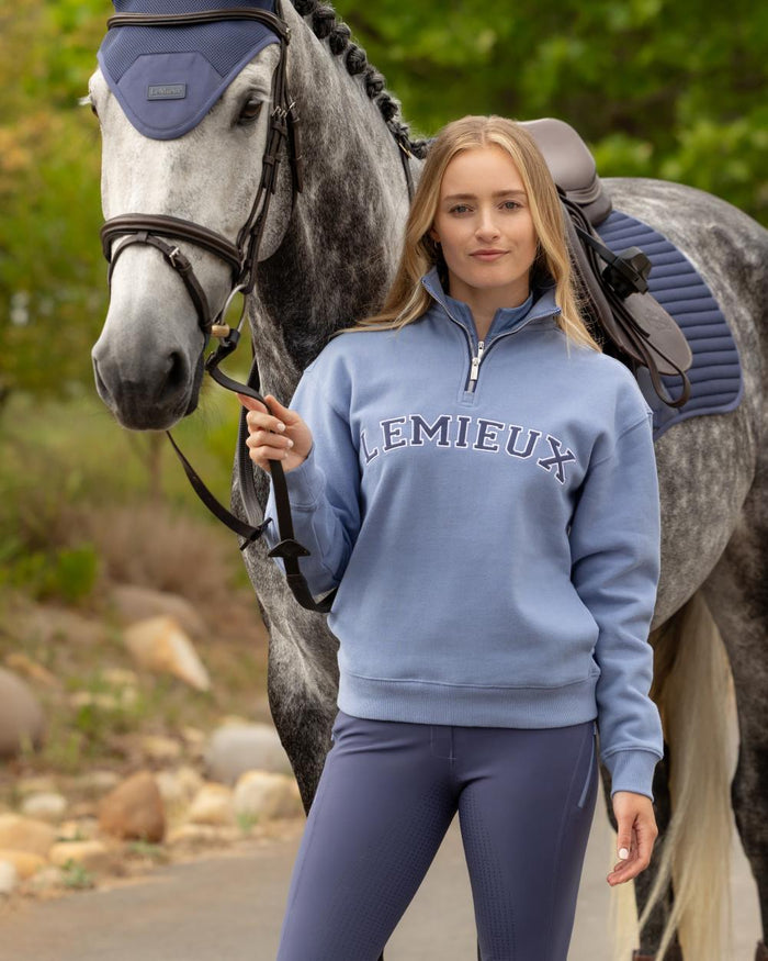 Powder Blue coloured LeMieux Womens Kelsie Quarter Neck Sweatshirt on outdoor background #colour_powder-blue