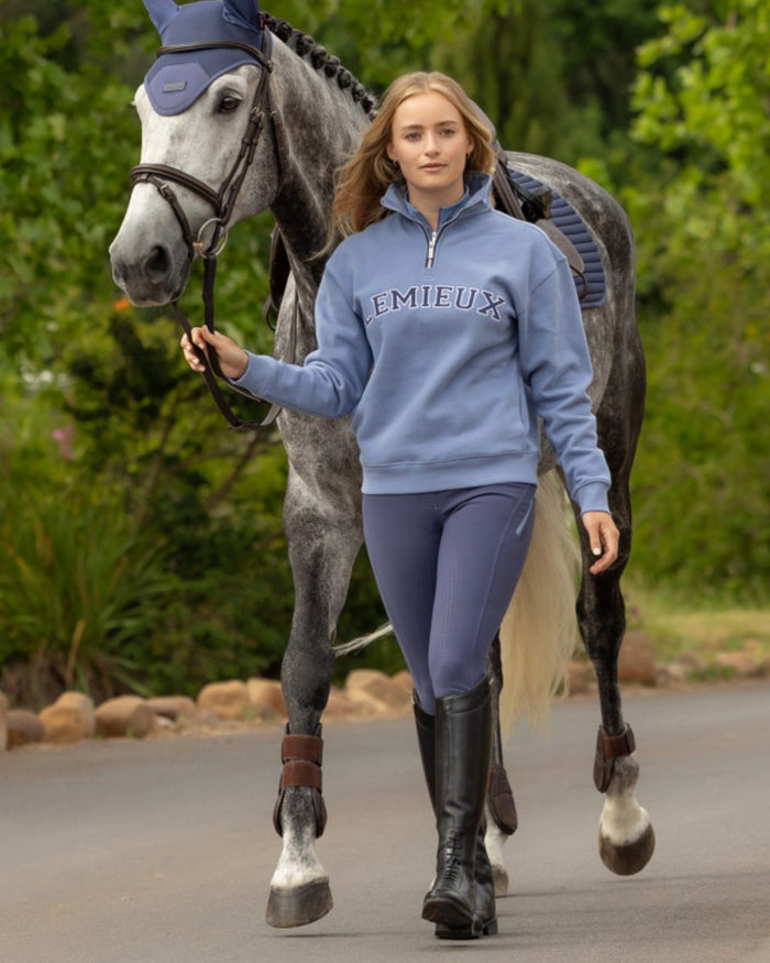 Powder Blue coloured LeMieux Womens Kelsie Quarter Neck Sweatshirt on outdoor background #colour_powder-blue
