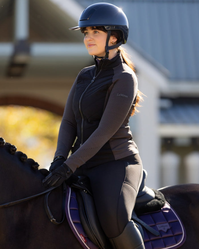 Black coloured LeMieux Womens Maddie Jacket on blurry background #colour_black