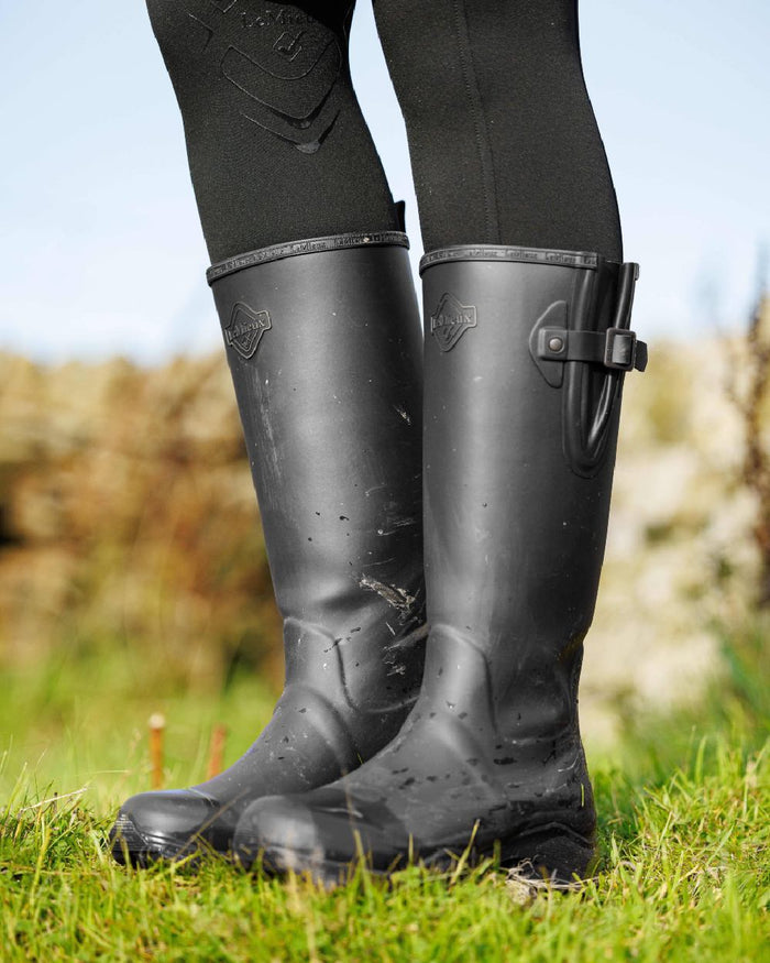 Black Coloured LeMieux Womens Ultra Stride Wellington Boots on grass background #colour_black
