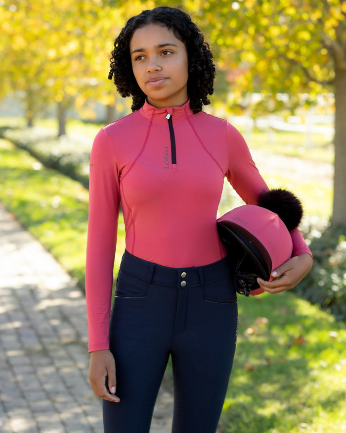 Cranberry coloured LeMieux Young Rider Classique Base Layer on tree background #colour_cranberry
