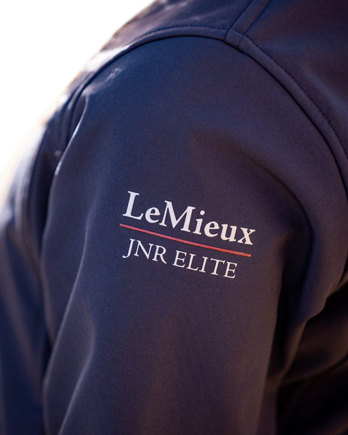 Navy coloured LeMieux Young Rider Elite Soft Shell Jacket on white background #colour_navy