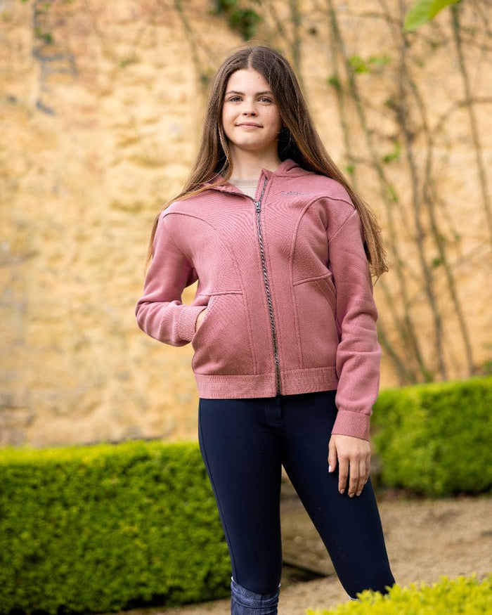 Peony coloured LeMieux Young Rider Hadley Hoodie on backyard background #colour_peony
