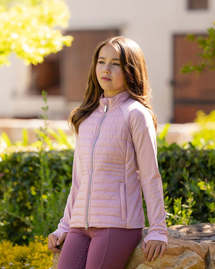Blossom coloured LeMieux Young Rider Josephine Jacket on backyard background #colour_blossom