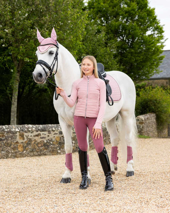 Blossom coloured LeMieux Young Rider Josephine Jacket on street background #colour_blossom