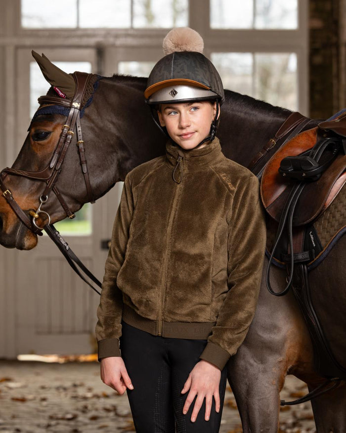 Alpine Coloured LeMieux Young Rider Libby Fleece Jacket On A Stable Background #colour_alpine