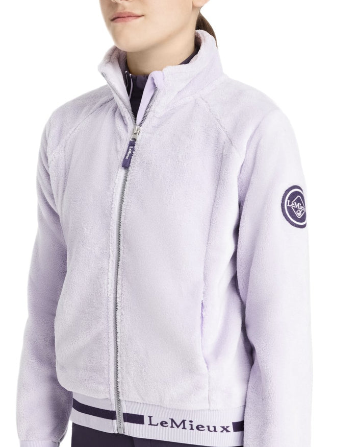 Lilac Coloured LeMieux Young Rider Libby Fleece Jacket On A White Background #colour_lilac