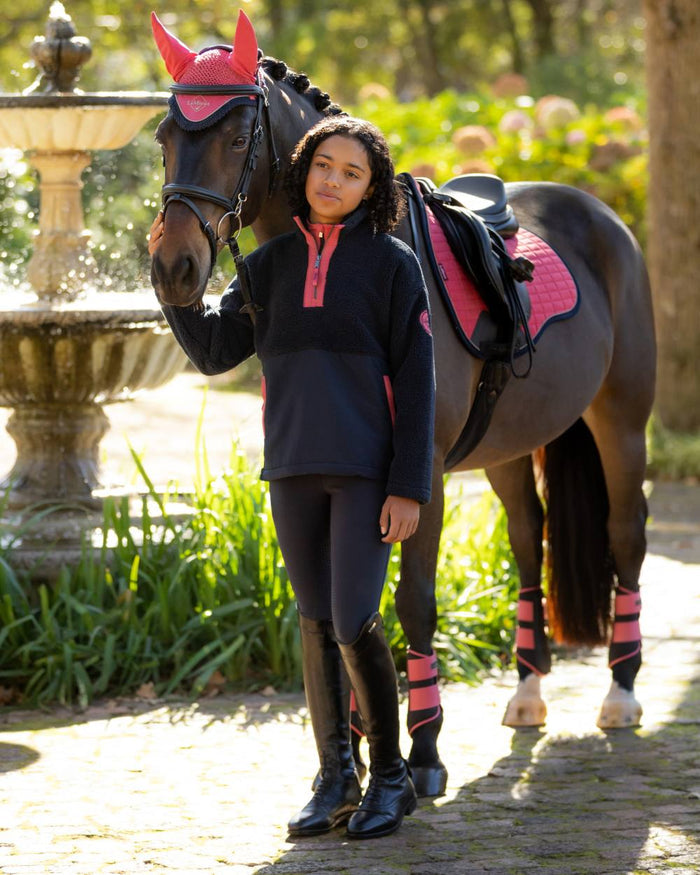 Navy coloured LeMieux Young Rider Tammy Teddy Fleece on garden background #colour_navy