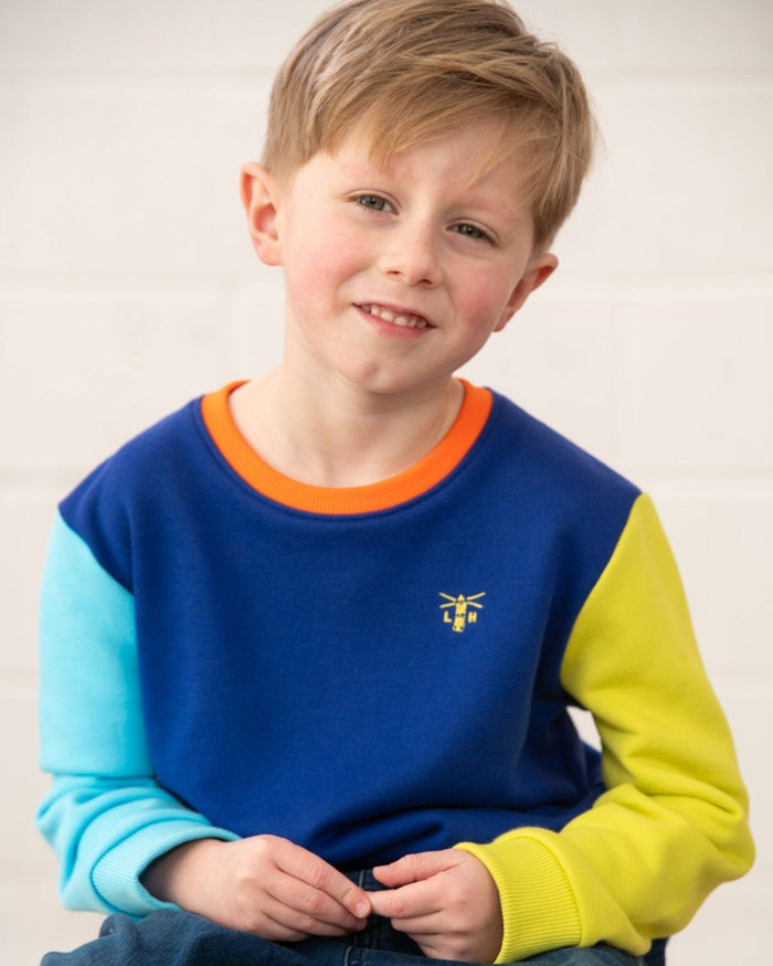 Blue Navy Lime coloured Lighthouse Childrens Finn Jersey on wall background #colour_blue-navy-lime