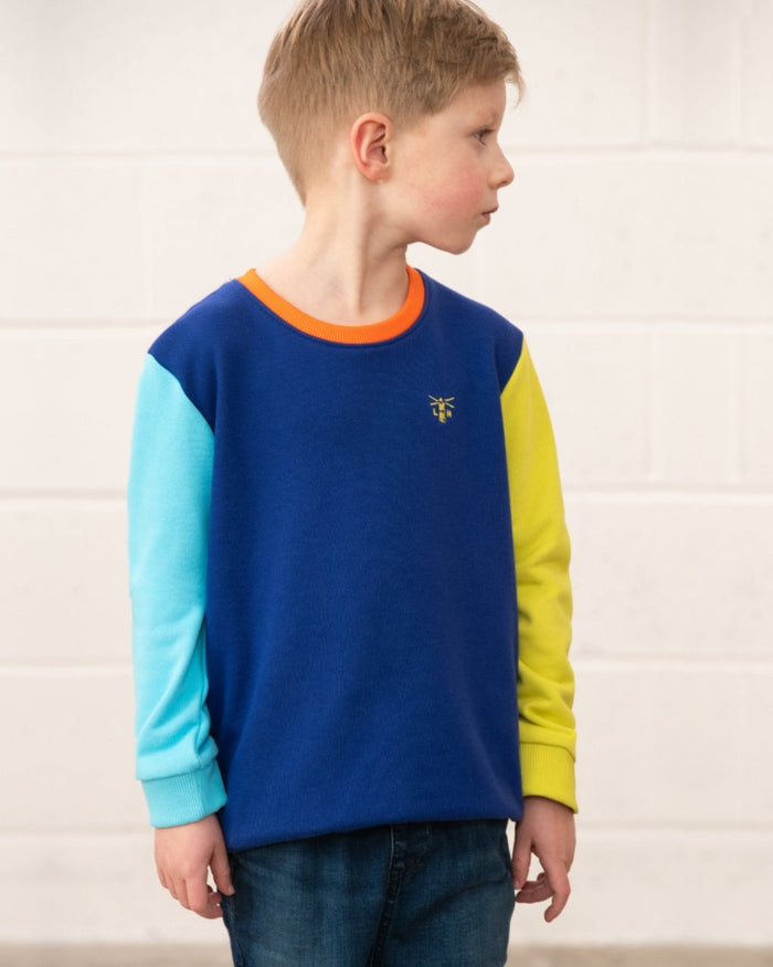 Blue Navy Lime coloured Lighthouse Childrens Finn Jersey on wall background #colour_blue-navy-lime