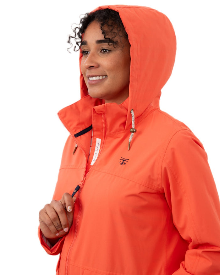 Coral coloured Lighthouse Ladies Beachcomber II Coat on white background #colour_coral