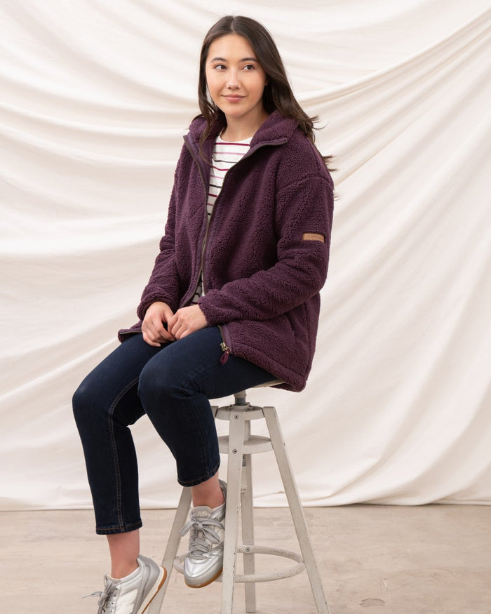 Cranberry coloured Lighthouse Ladies Cobh Full Zip Fleece Jacket on curtain background #colour_cranberry