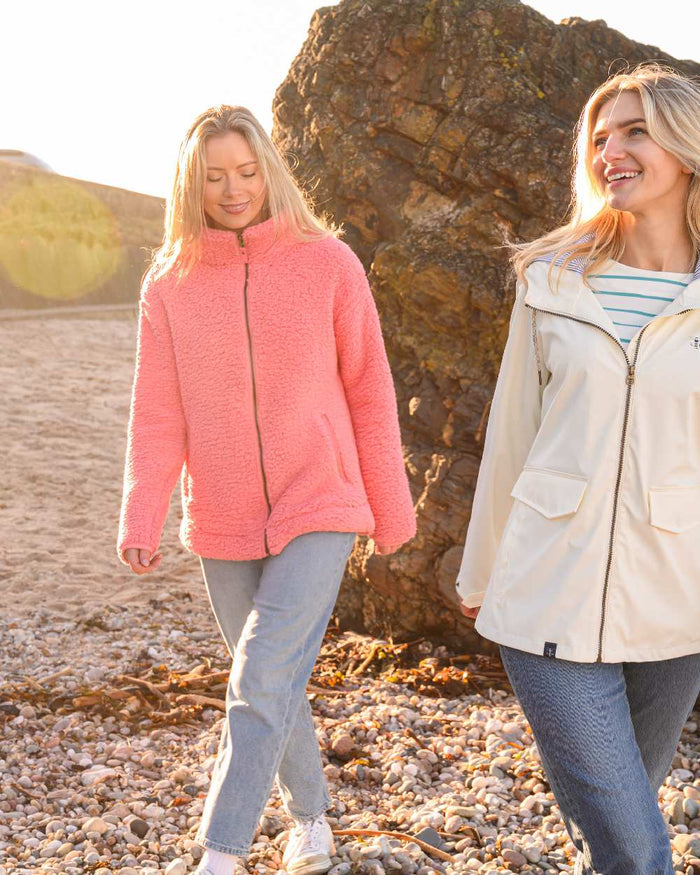 Sugar Coral coloured Lighthouse Ladies Seashell Full Zip Sherpa Fleece on rock background #colour_sugar-coral
