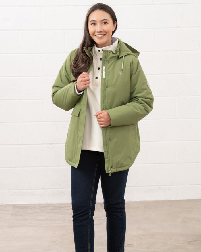 Sea Kelp coloured Lighthouse Ladies Tess Coat on wall background #colour_sea-kelp