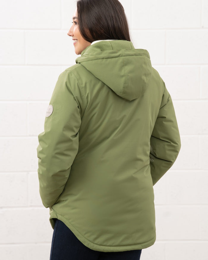 Sea Kelp coloured Lighthouse Ladies Tess Coat on wall background #colour_sea-kelp