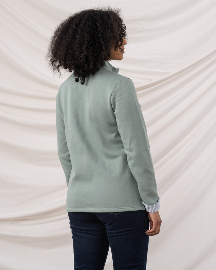 Sage coloured Lighthouse Shore Jersey Top on curtain background #colour_sage