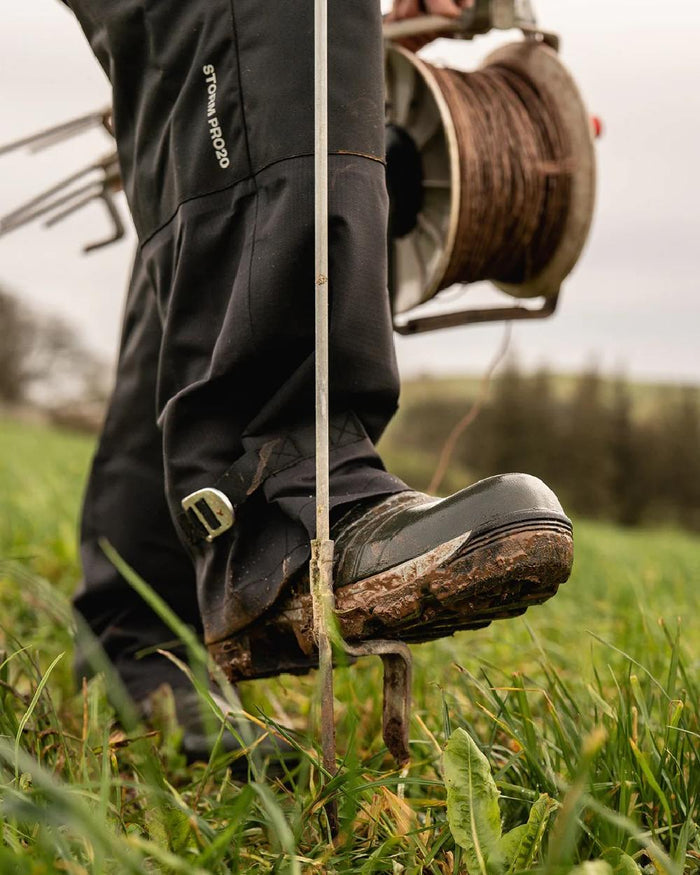 Black coloured Line 7 Mens Territory Storm Pro20 Waterproof Overtrouser on farm background #colour_black