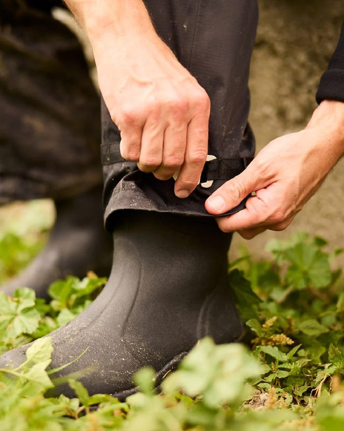Black coloured Line 7 Mens Territory Storm Pro20 Waterproof Overtrouser on farm background #colour_black