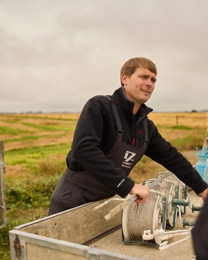 Black Coloured Line 7 Mens Territory Wind Pro Half Zip Fleece Jacket on farm background #colour_black