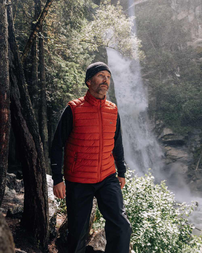 Burnt Orange Coloured Mac In A Sac Mens Synergy Gilet on waterfall background #colour_burnt-orange