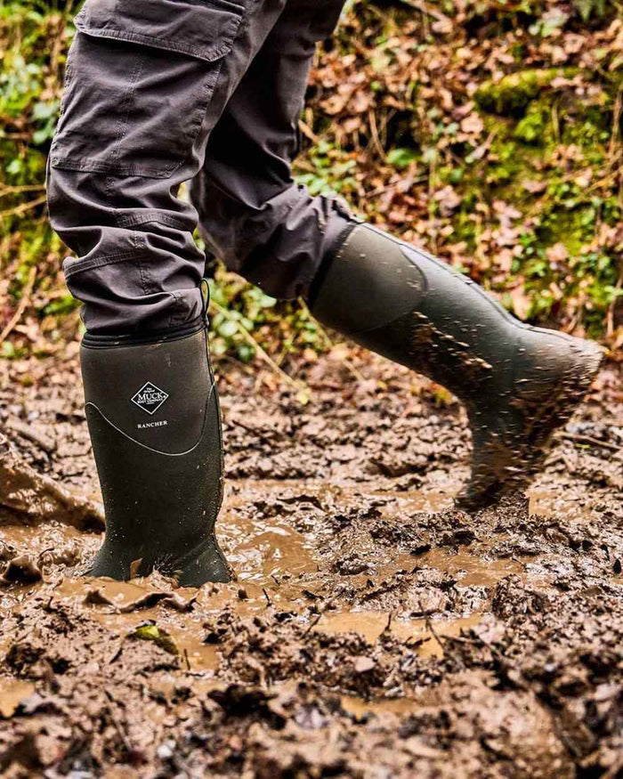 Olive coloured Muck Boots Mens Muck Rancher Tall Boots on muddy background #colour_olive