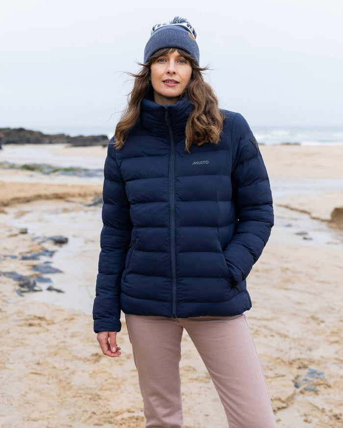 Ombre Blue Coloured Musto Bobble Hat on beach background #colour_ombre-blue