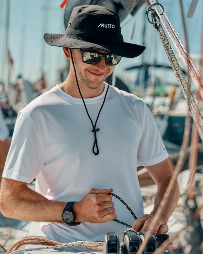 Black Coloured Musto Fast Dry Brimmed Hat on Blurry Background
#colour_black