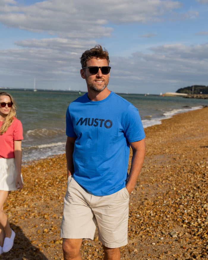 Nebulas Blue Coloured Musto Logo Cotton Tee on Beach Background
#colour_nebulas-blue