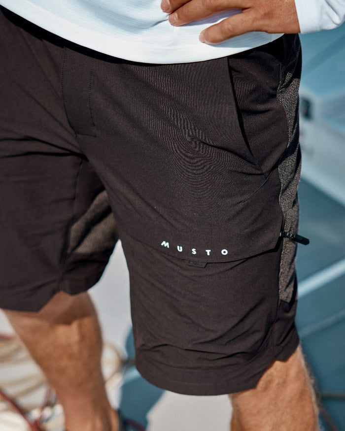 Black Coloured Musto Mens Evo Performance Stretch Shorts on outdoor background #colour_black
