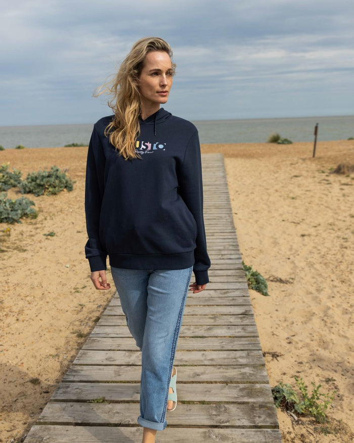 Navy Coloured Musto Womens 1964 Hoodie On A Beach Background #colour_navy