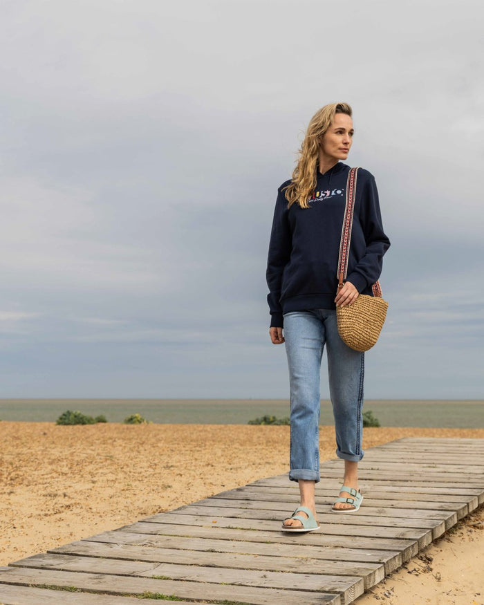 Navy Coloured Musto Womens 1964 Hoodie On A Beach Background #colour_navy