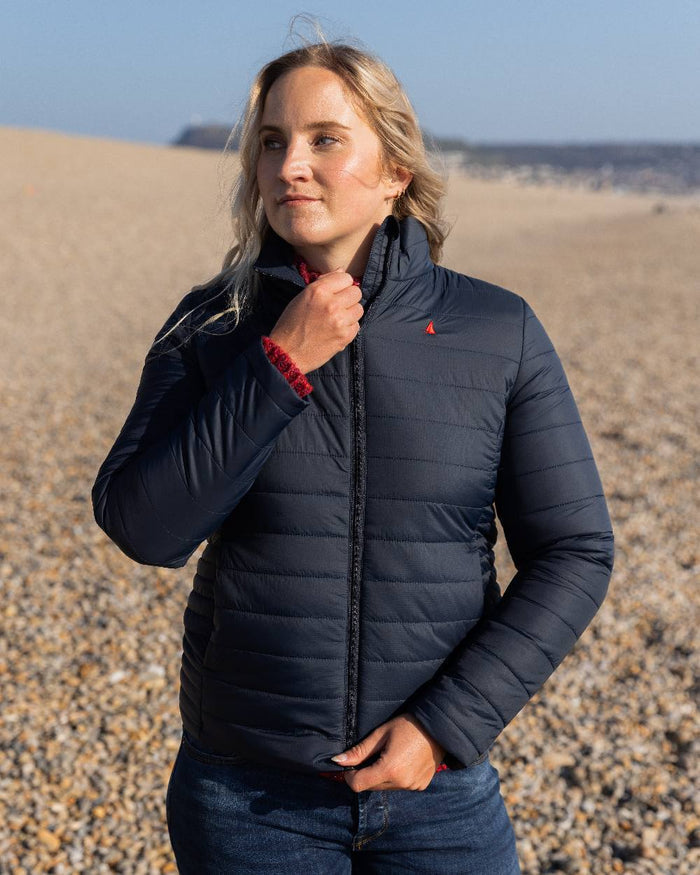 Navy Coloured Musto Womens Original Lite Puffer Jacket on beach background #colour_navy