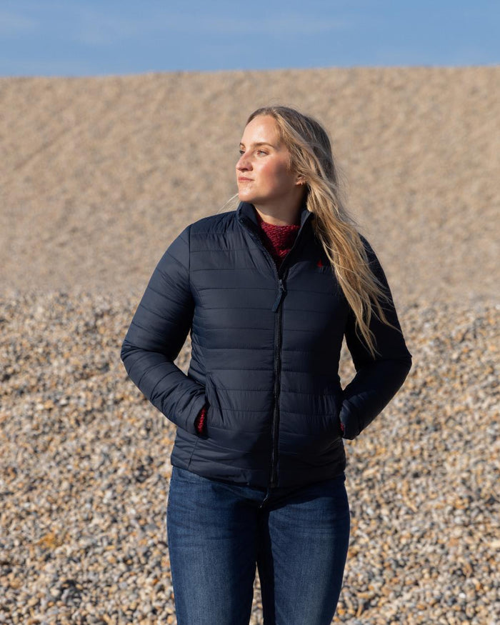 Navy Coloured Musto Womens Original Lite Puffer Jacket on beach background #colour_navy
